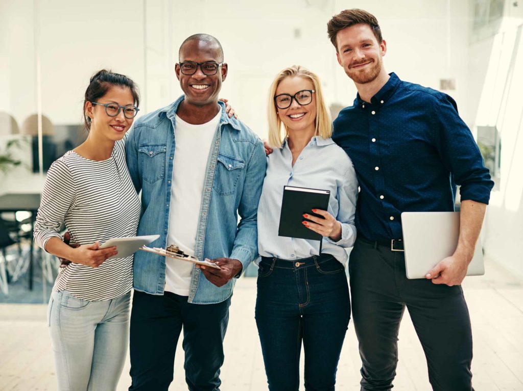 QBNW_smiling-team-of-young-business-people